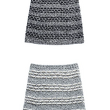 Two knitted cowls on a white surface
