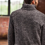 A man wearing a knitted turtleneck sweater