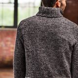 A man wearing a knitted turtleneck sweater