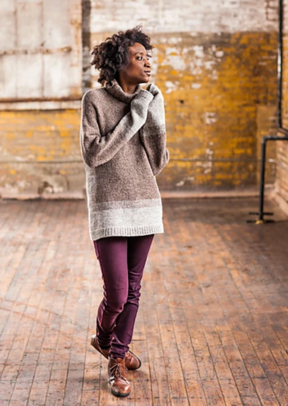 A woman wearing a knitted turtleneck sweater