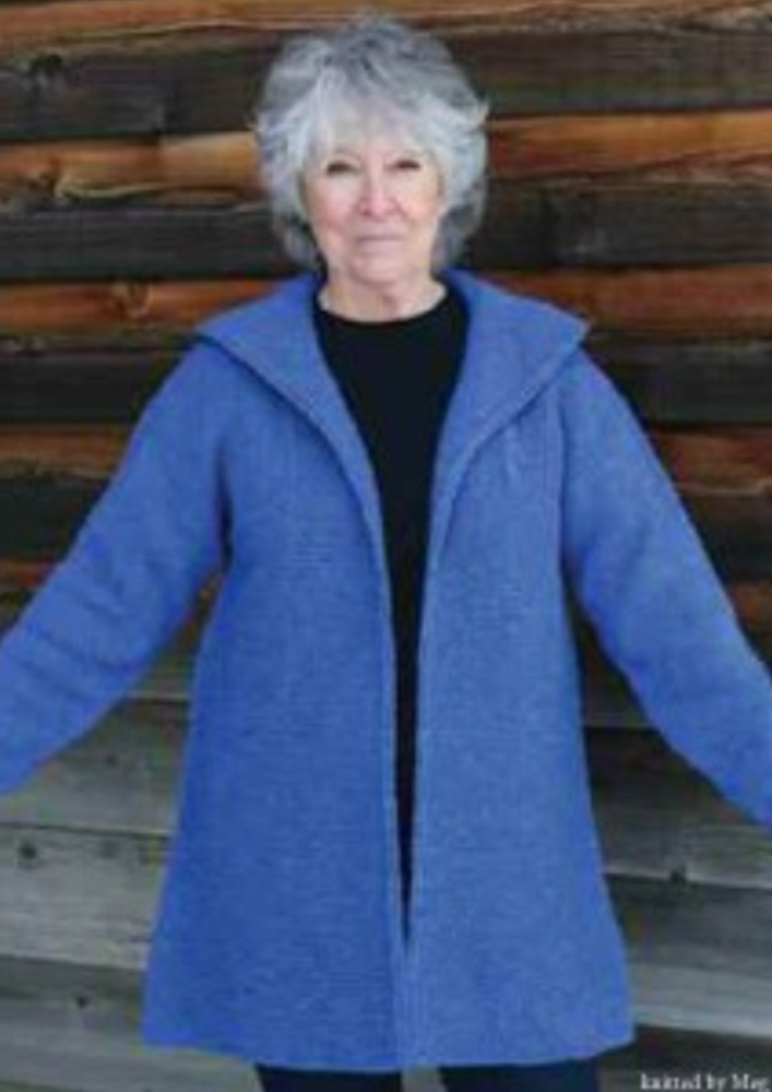 A woman wearing a knitted blue coat
