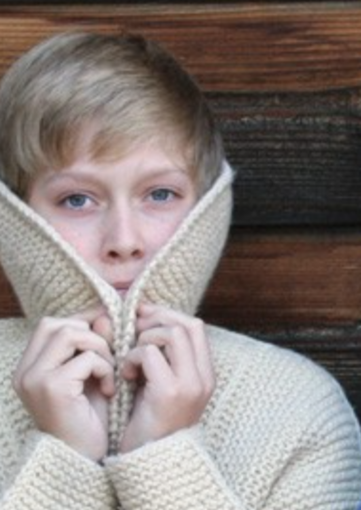 A child wearing a knitted coat