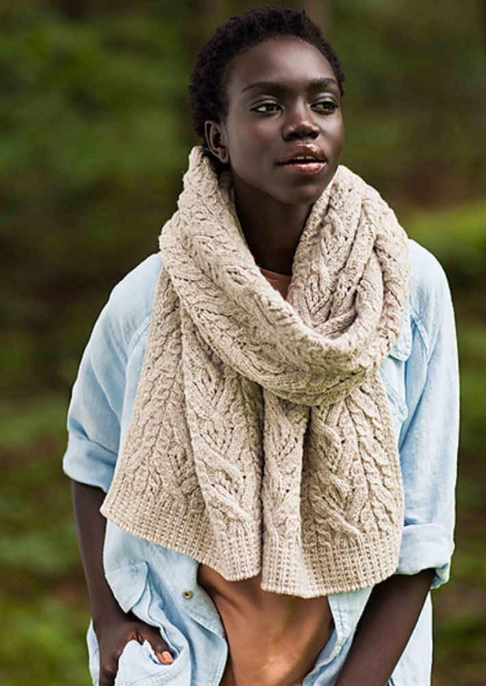 A woman wearing a knitted shawl/scarf
