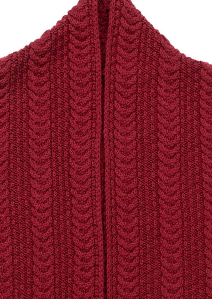 A close up of a knitted cabled cardigan sweater