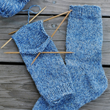 A pair of knitted socks on knitting needles