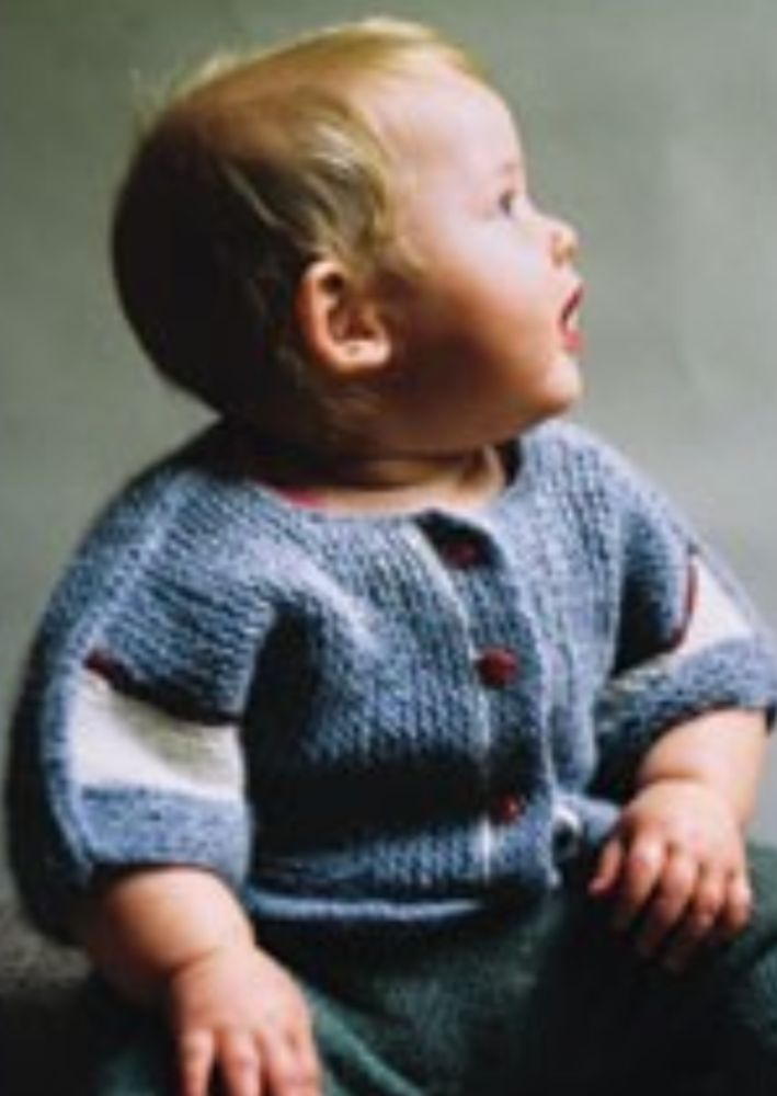 A baby wearing a knitted jacket