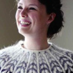A woman wearing a colorwork sweater