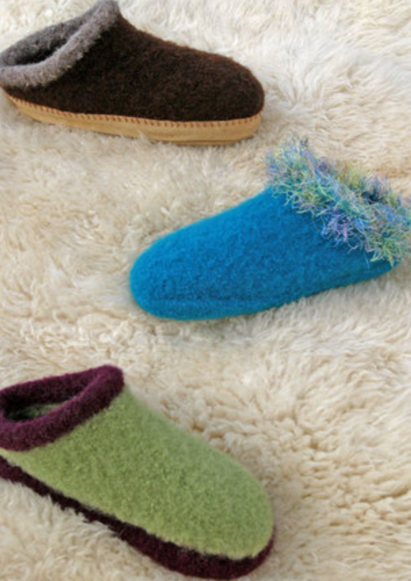 Three felted clogs on a furry surface