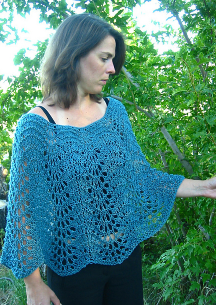 A woman wearing a knitted poncho