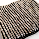 A knitted Brioche cowl on a white background