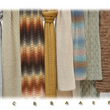 A row of different knitted scarves