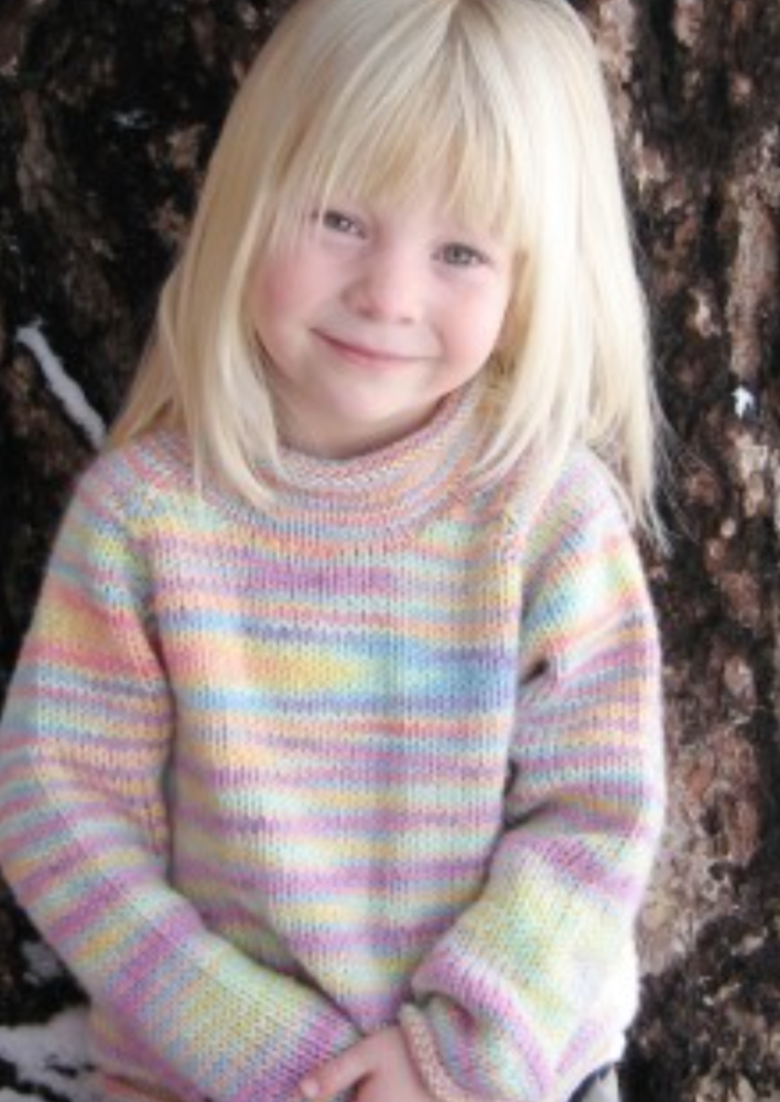 A female child wearing a knitted sweater
