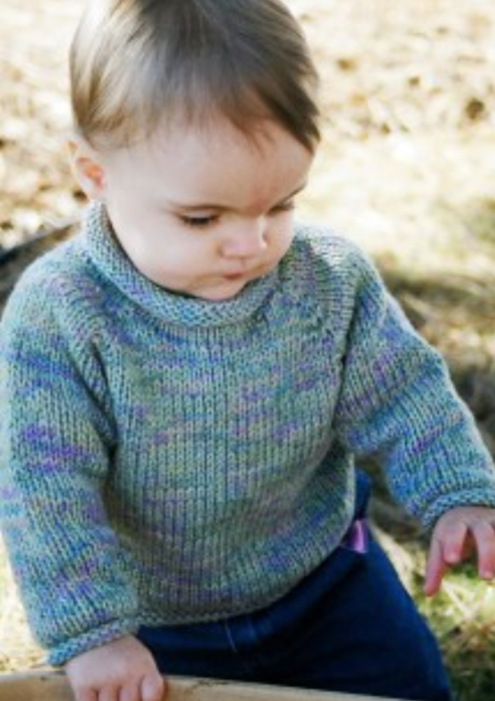 A baby wearing a knitted sweater