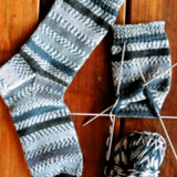 A pair of knitted socks on knitting needles