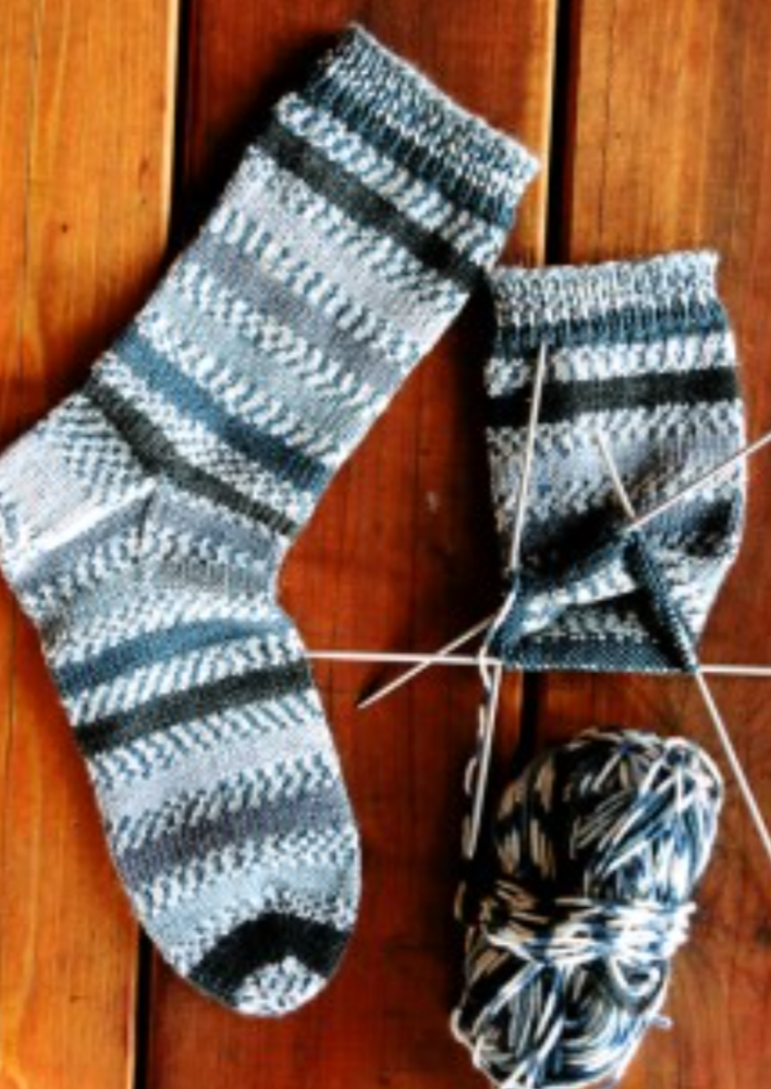 A pair of knitted socks on knitting needles