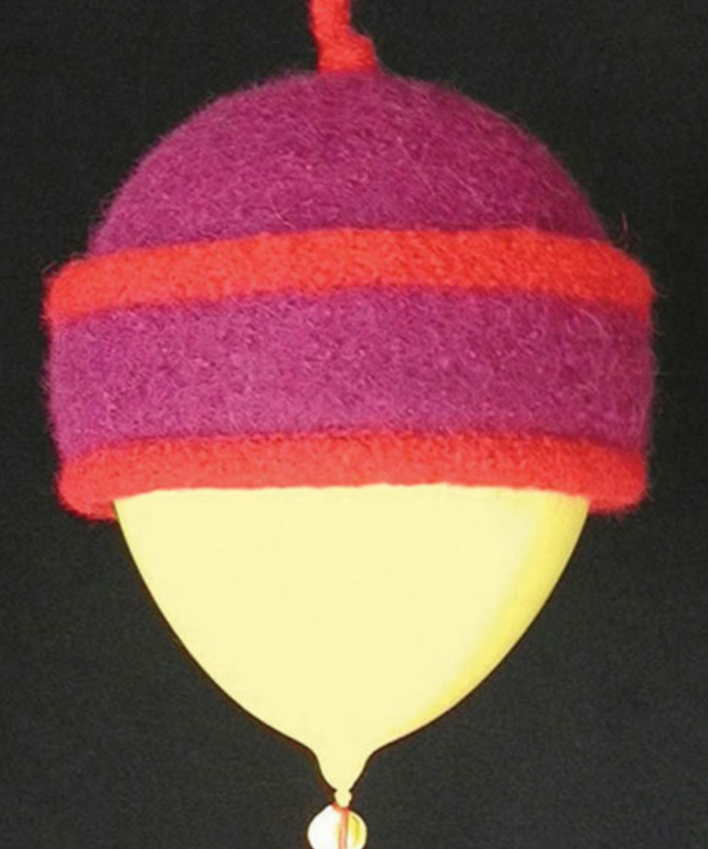 A colorful felted hat modeled on a balloon