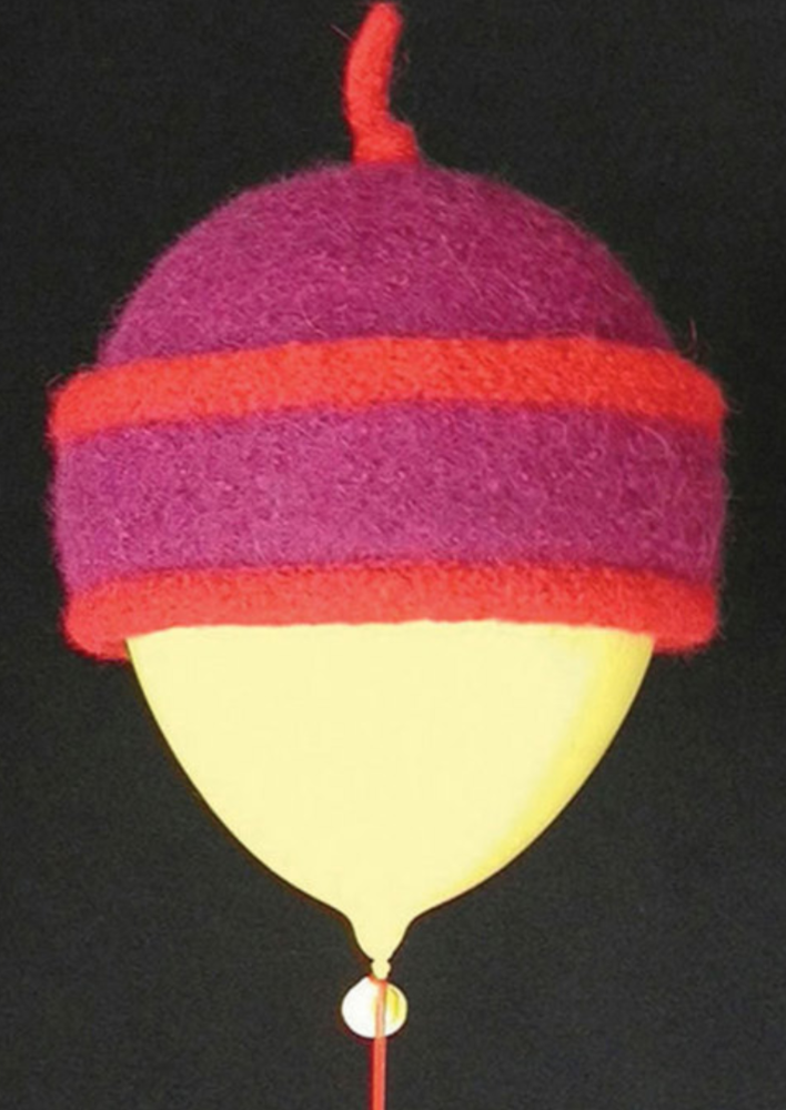 A colorful felted hat modeled on a balloon