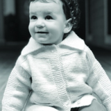 A baby wearing a knitted sweater