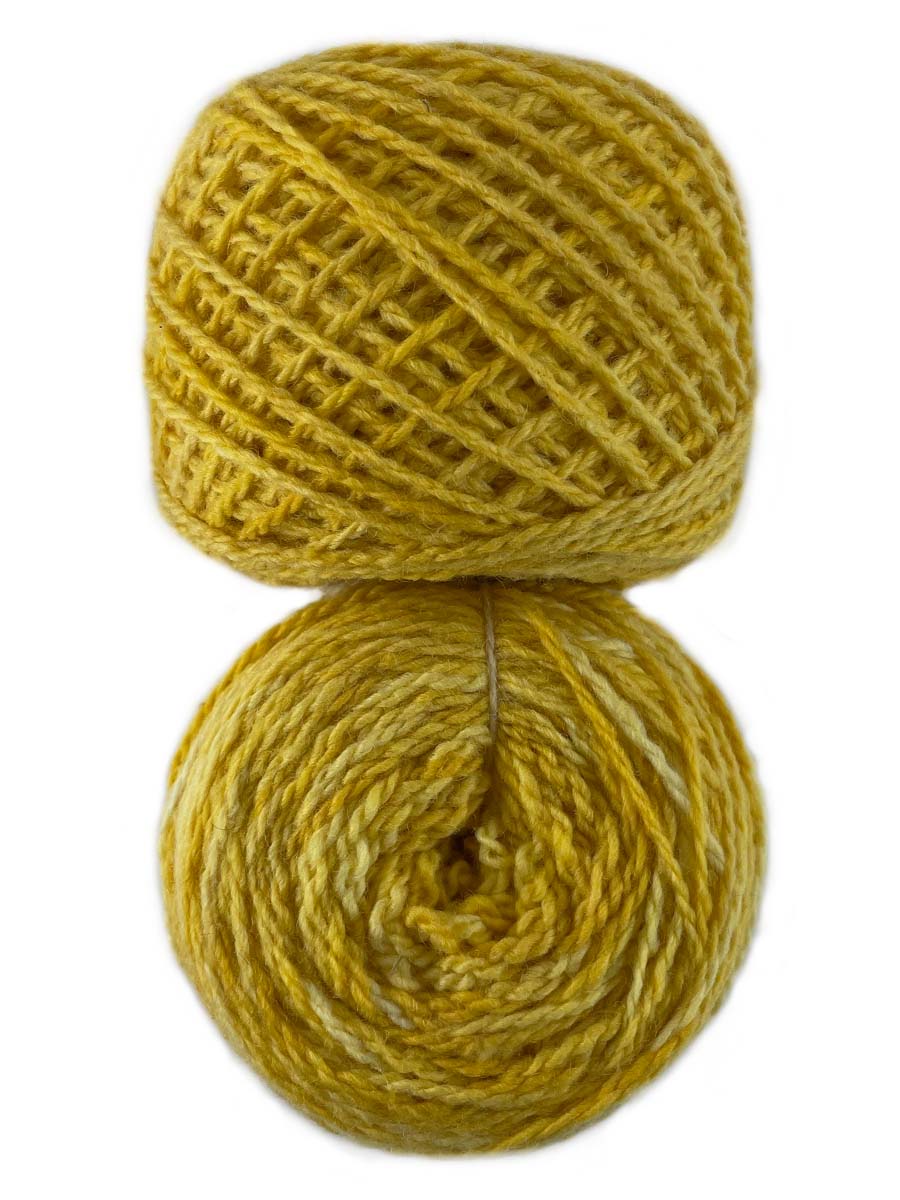 Photo of two balls of yellow Tronstad yarn