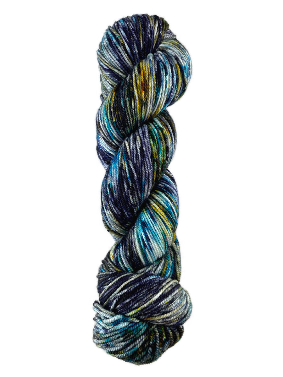 A blue, black, and yellow skein of Western Sky Knits Merino 17 DK yarn
