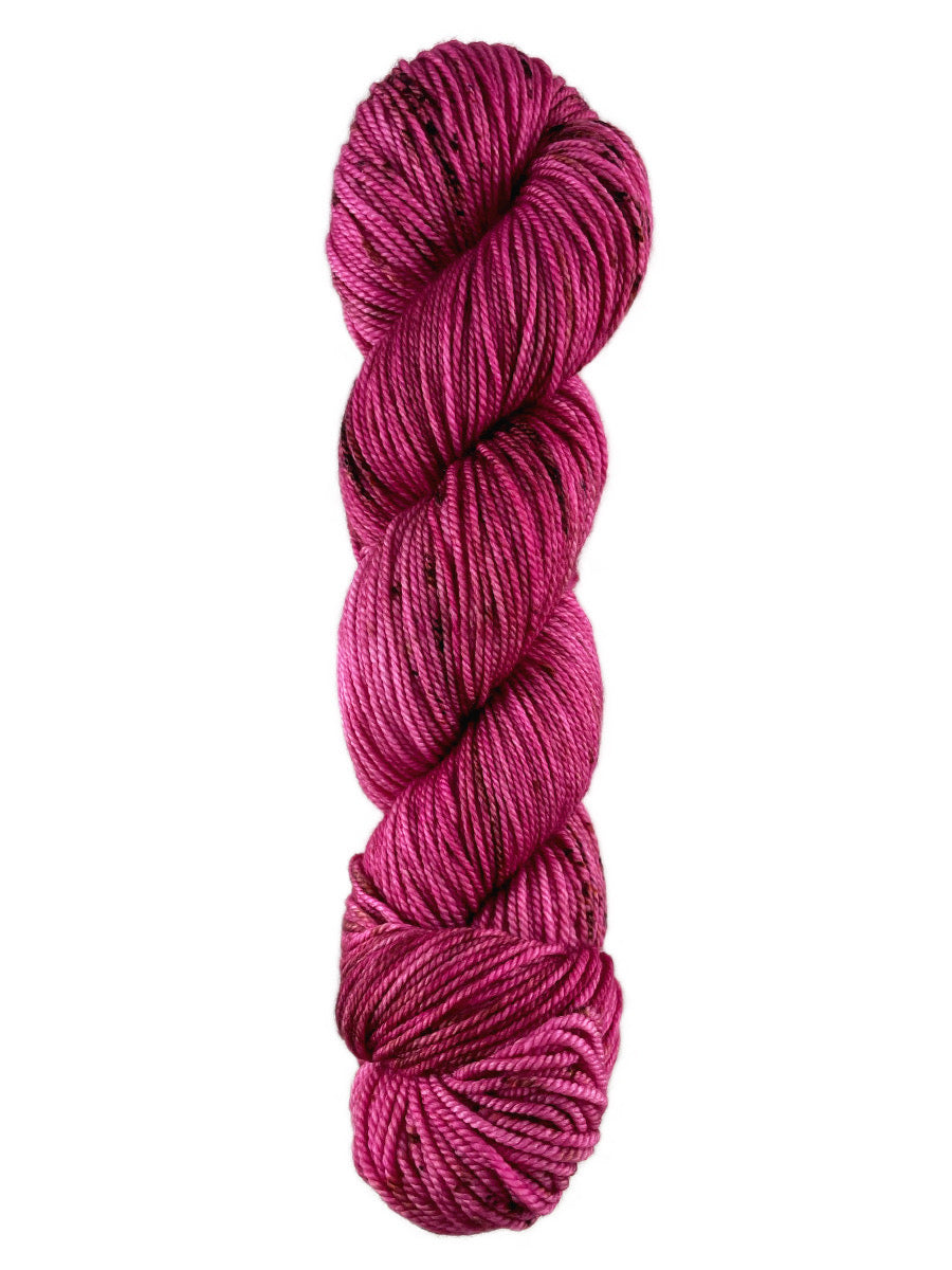 A pink skein of Western Sky Knits Merino 17 DK yarn