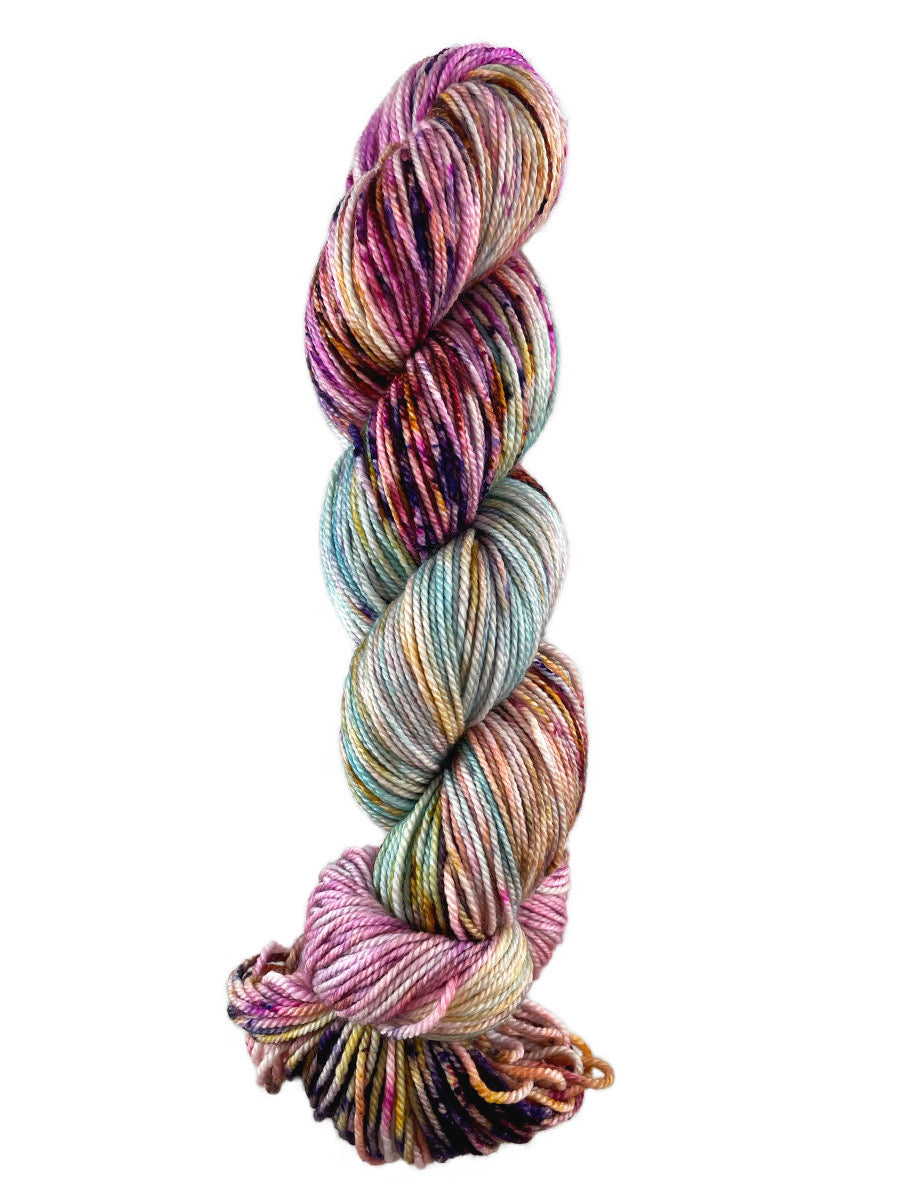A pink and blue skein of Western Sky Knits Merino 17 DK yarn