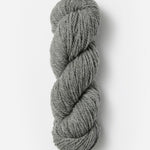 Skein of Blue Sky Fibers Woolstok yarn in the color light grey