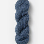 Skein of Blue Sky Fibers Woolstok yarn in the color denim blue