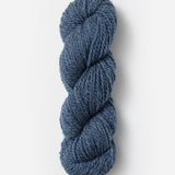 Skein of Blue Sky Fibers Woolstok yarn in the color denim blue