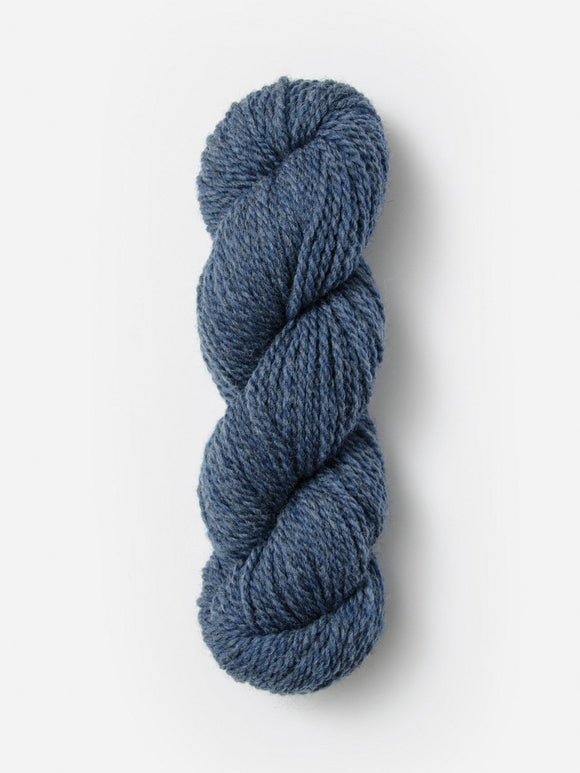 Skein of Blue Sky Fibers Woolstok yarn in the color denim blue