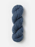 Skein of Blue Sky Fibers Woolstok yarn in the color denim blue