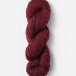 Skein of Blue Sky Fibers Woolstok yarn in the color wine red