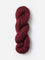 Skein of Blue Sky Fibers Woolstok yarn in the color wine red