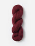 Skein of Blue Sky Fibers Woolstok yarn in the color wine red