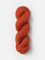 Skein of Blue Sky Fibers Woolstok yarn in the color orange
