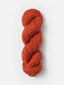 Skein of Blue Sky Fibers Woolstok yarn in the color orange