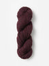Skein of Blue Sky Fibers Woolstok yarn in the color maroon