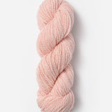Skein of Blue Sky Fibers Woolstok yarn in the color light pink
