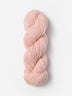 Skein of Blue Sky Fibers Woolstok yarn in the color light pink