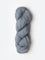 Skein of Blue Sky Fibers Woolstok yarn in the color light heathered grey