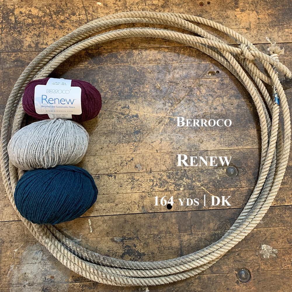 A photo showing three balls of Berroco Renew yarn in a lasso on a wooden surface