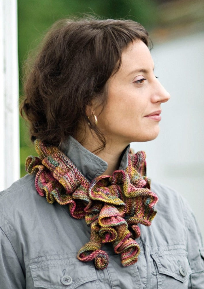 A woman wearing a ruffled, knitted scarf