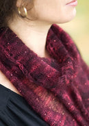 A woman wearing a beaded, knitted scarf