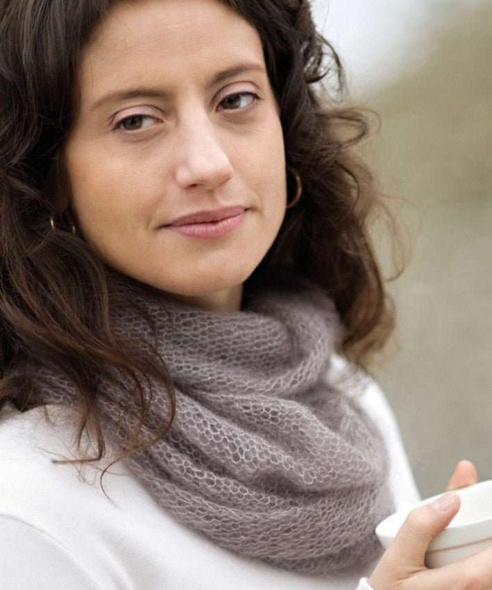 A woman wearing a knitted cowl