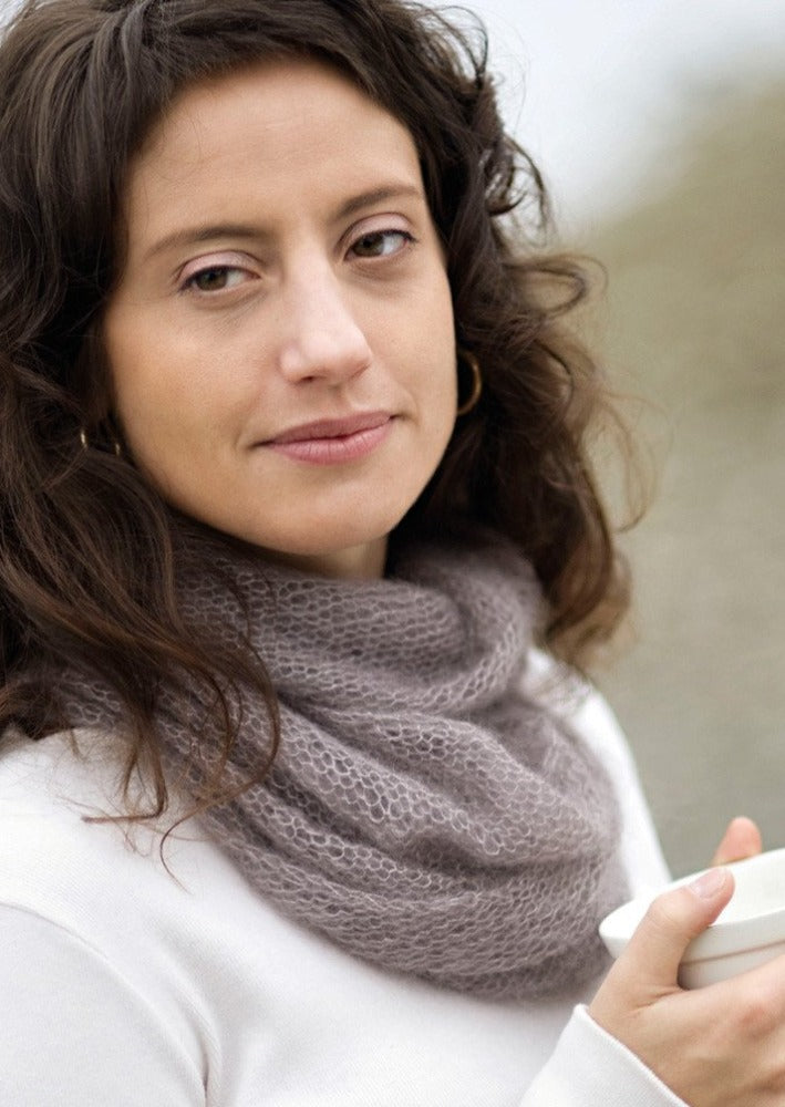 A woman wearing a knitted cowl