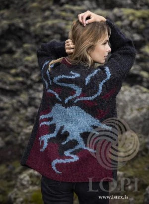 Woman in a Lopi sweater with a volcano on the back