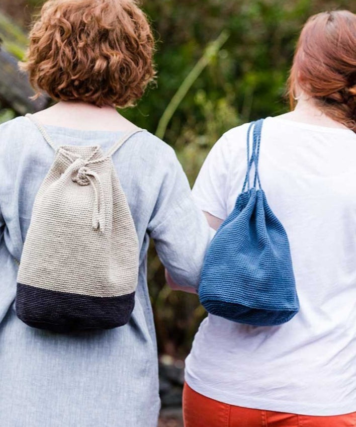 Two women wearing bags