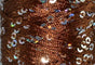 A close-up photo of SWTC String Me Along brown colored sequined thread