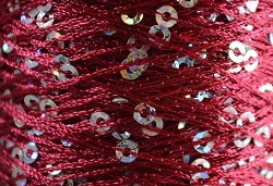 A close-up photo of SWTC String Me Along dark pink colored sequined thread