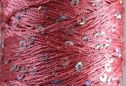 A close-up photo of SWTC String Me Along rose pink colored sequined thread
